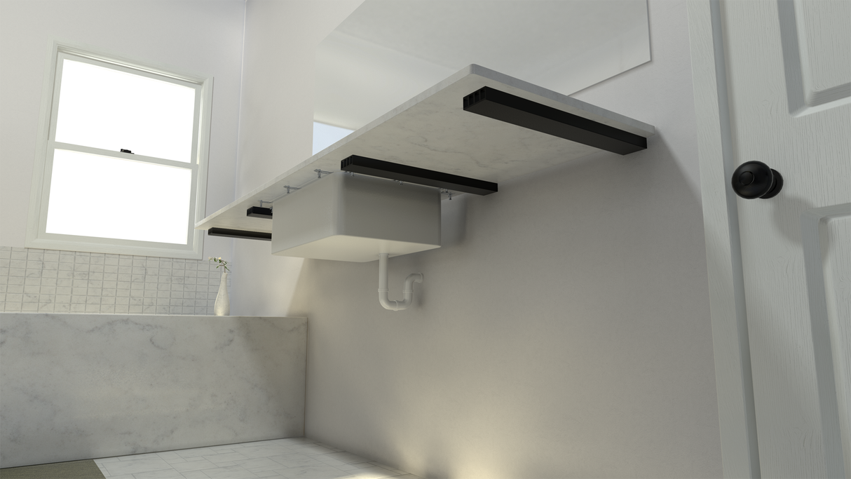 The bottom side of a white marble bathroom vanity held in place by 4 Original Free Floating Vanity Brackets on a white wall with a white marbled tub and bathroom window in the background.