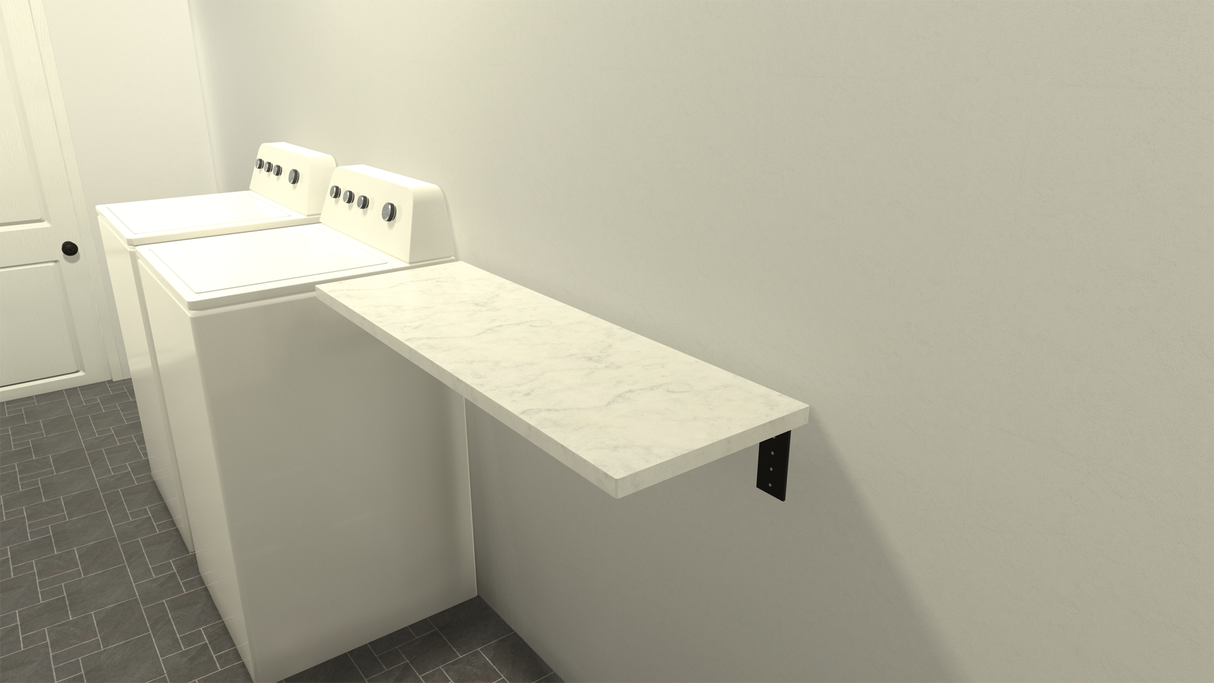 A small white marble floating shelf on a white wall with a washing machine and dryer in the background on a grey tile floor.