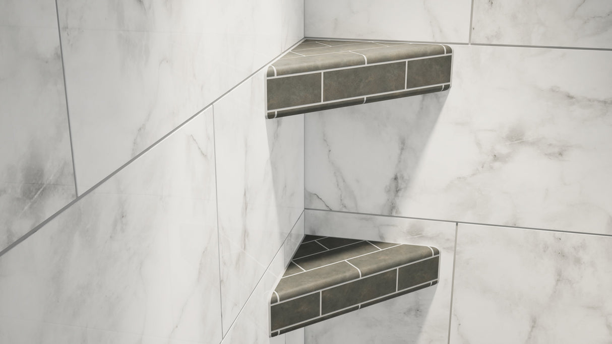 Two original corner shower shelves covered in gray tile attached to a marble bathroom wall.