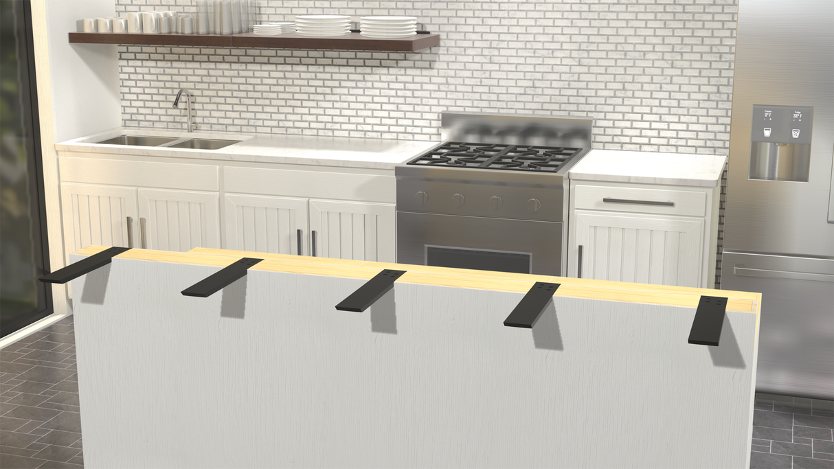 A front view of an unfinished white kitchen island showing 5 Black L Brackets with white counters and stainless steel appliances in the background.