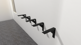 5 Industrial Large Shelf Brackets attached to a white wall with a gray tile floor.